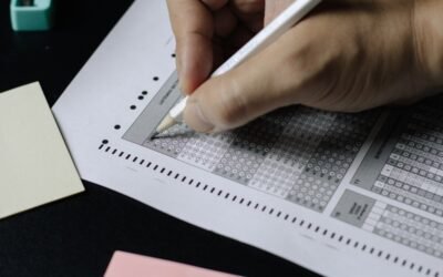 Pen on an answer sheet being checked against an answer key