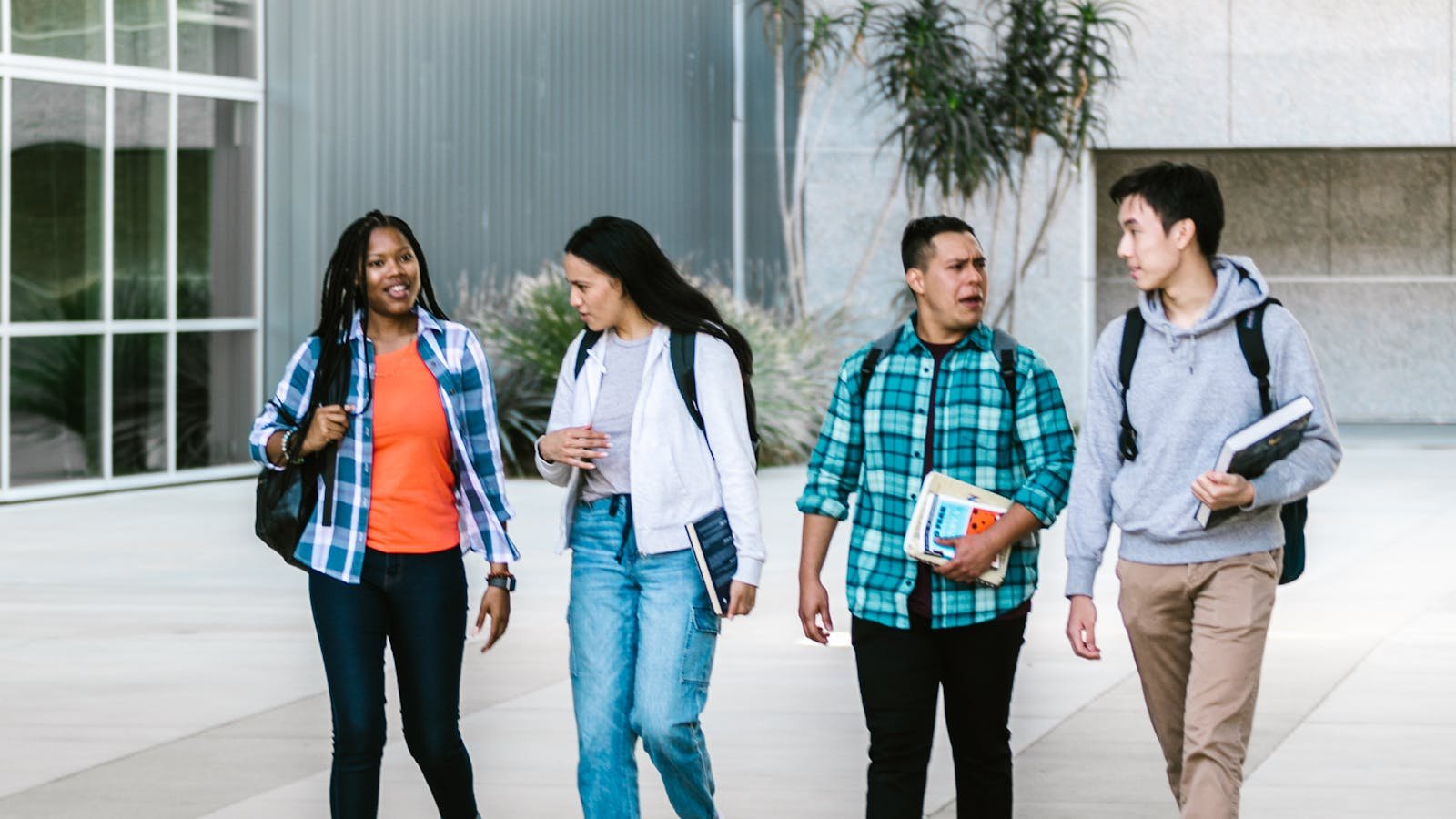Group of college students walking on a campus